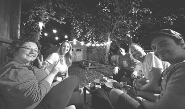 A group of people smiling for a backyard photo