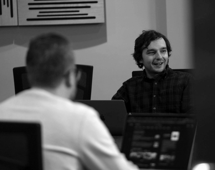 A person smiling and discussing something in a meeting