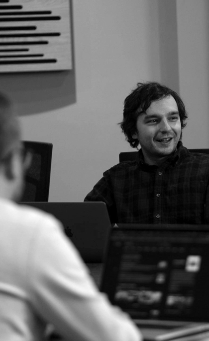 A person smiling and discussing something in a meeting
