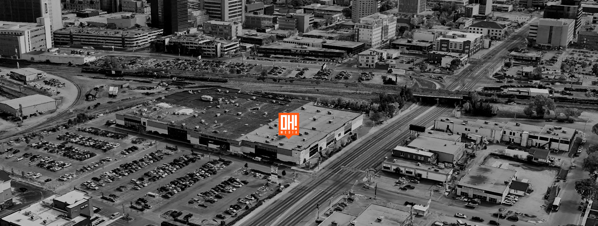 An overhead view of Regina Center Crossing with the OH! Media logo map marker